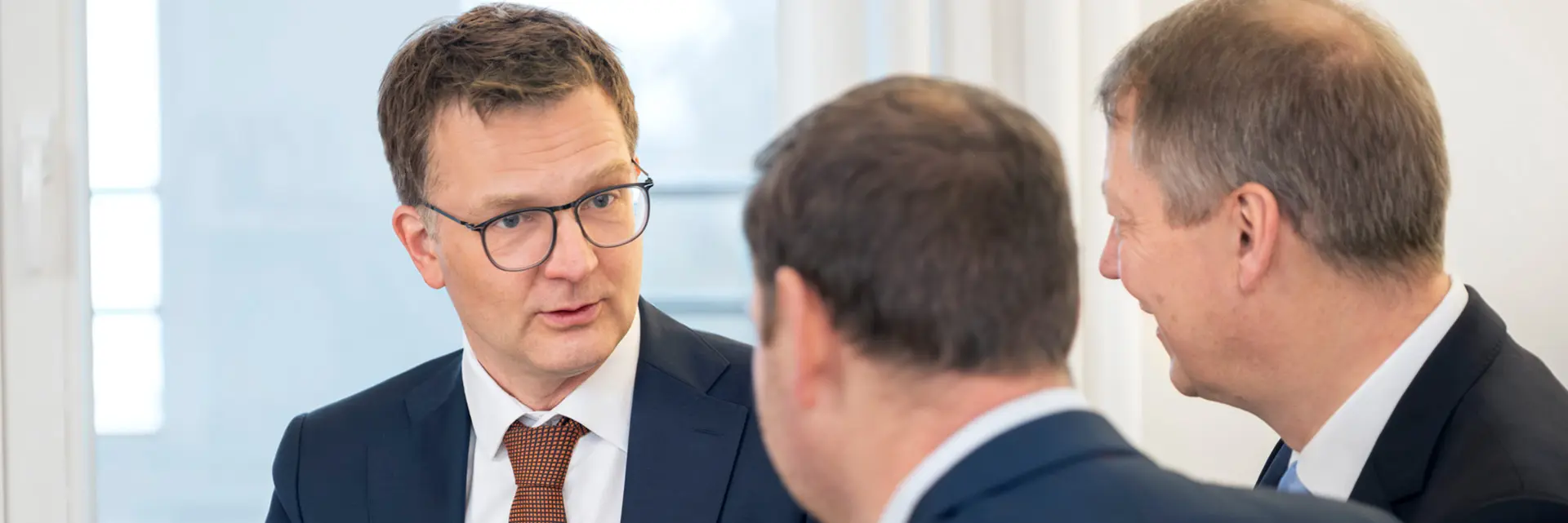 Drei Leute unterhalten sich am Tisch